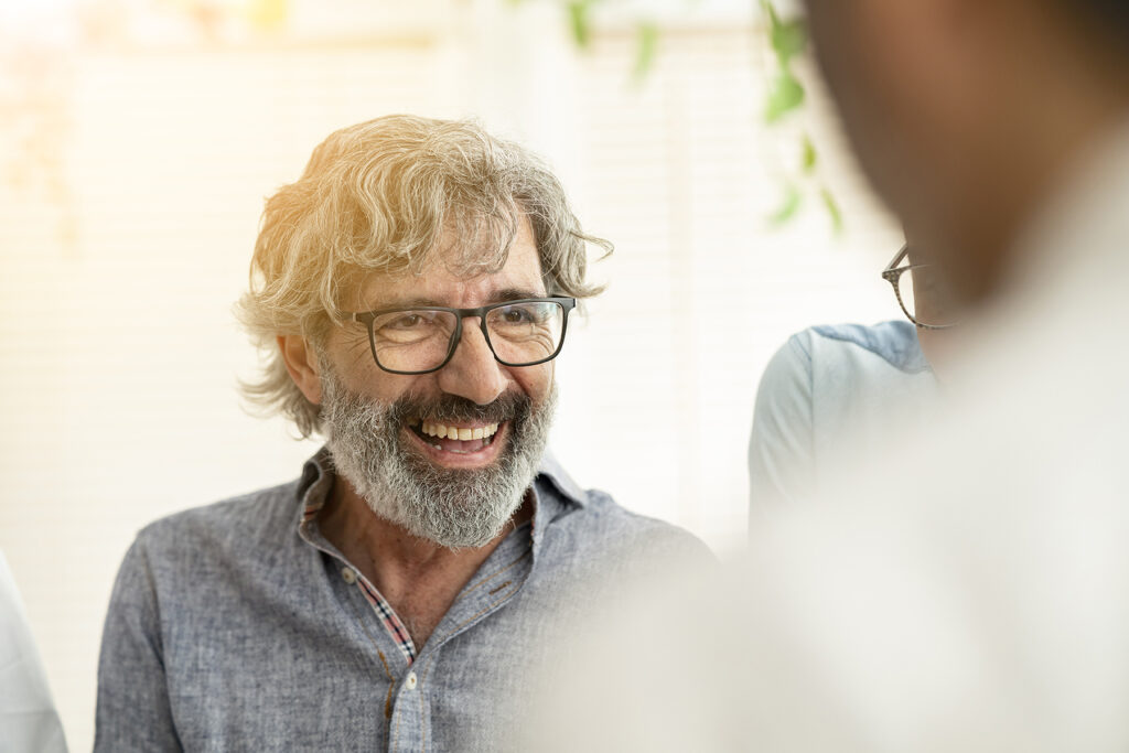 senior businessman smiling with work group